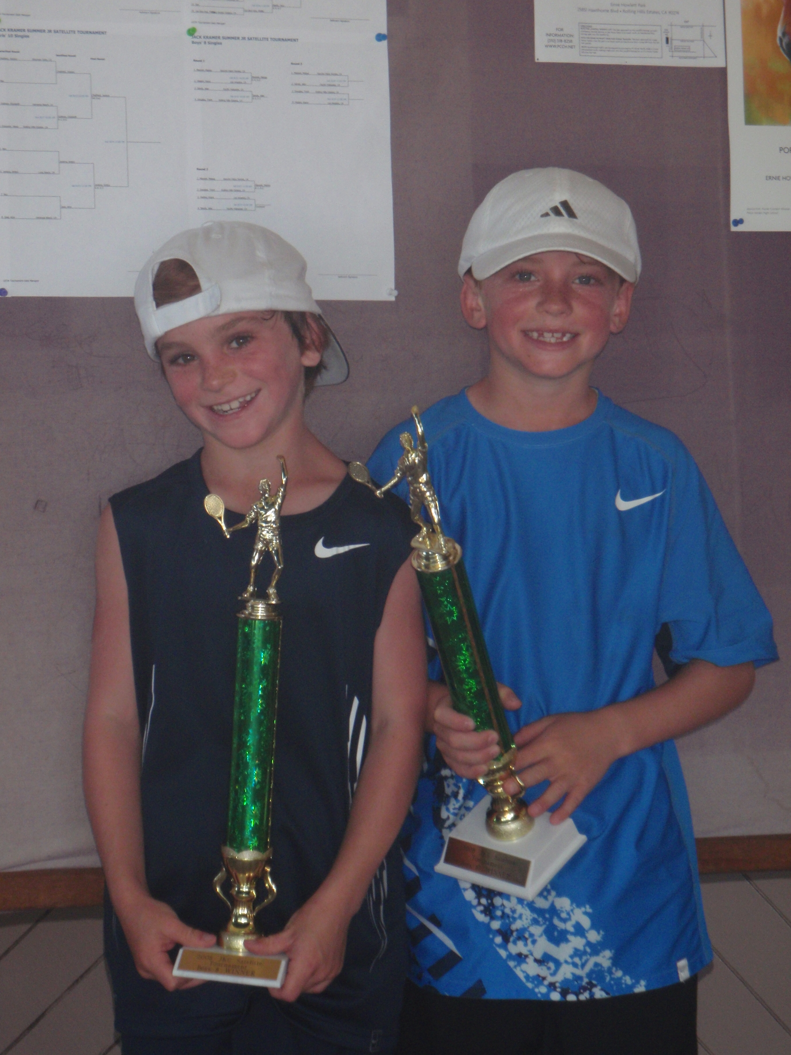 Brothers Jake (left) and RJ Sands with their trophies after winning their respective age divisions at the Jack Kramer Club last week.